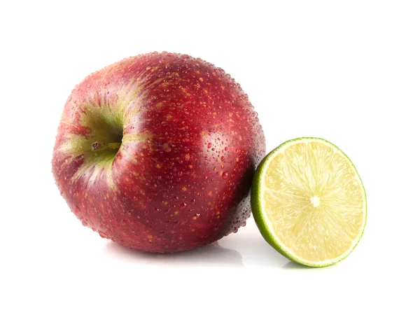Isolated red apple with half of lime on a white — Stock Photo, Image