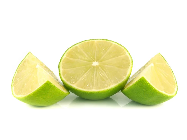 Isolated green lime half with slices on white — Stock Photo, Image