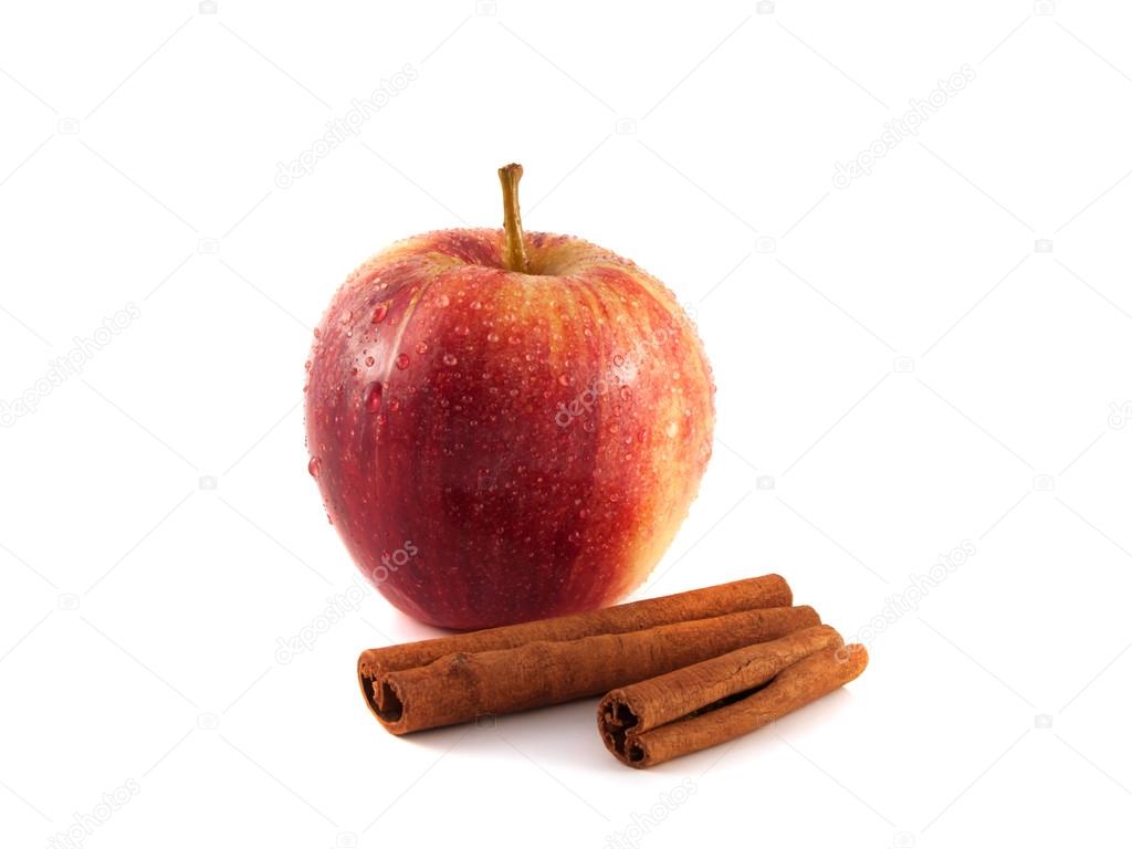 Isolated wet red apple with cinnamon on a white