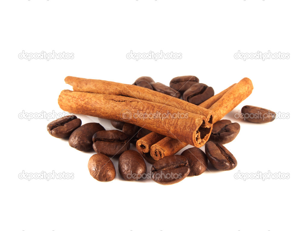 Coffee beans with cinnamon pods on white