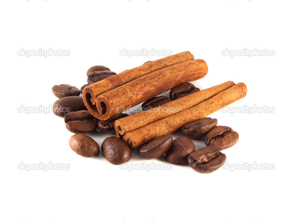 Coffee beans with cinnamon sticks on white