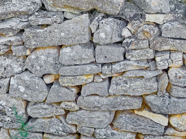 Frontal shot of the detail of traditional drywall as a fence of dirt road in Promina county in Croatia. Croatian drywall construction is a protected intangible cultural heritage of humanity by UNESCO.