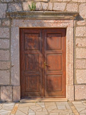 Old traditional Dalmatian church door from Zagora in Croatia, made of stone.