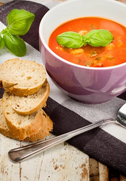 Tasty fresh tomato soup basil and bread — Stock Photo, Image