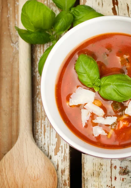 Tasty fresh tomato soup and basil — Stock Photo, Image