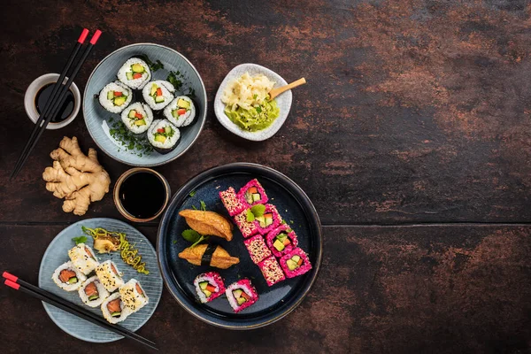Japanese sushi food. Maki ands rolls with tuna, salmon, shrimp, crab and avocado. Assorted sushi. Rainbow sushi roll, uramaki, hosomaki and nigiri.