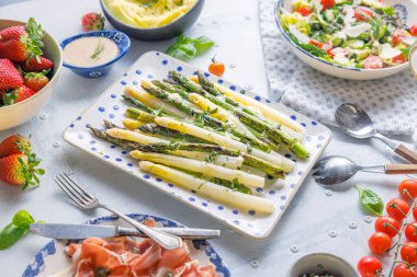 Green and white asparagus on the plate. Tasty and healthy regional vegetables