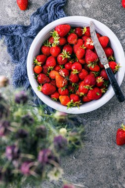 Koyu renkli taş masadaki olgun çilekler..