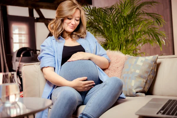 Pregnant Woman Sitting Sofa Looking Her Belly — Stockfoto