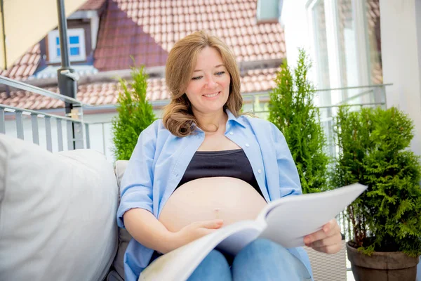 Young Pregnant Woman Reading Book Balcony Home — Stockfoto