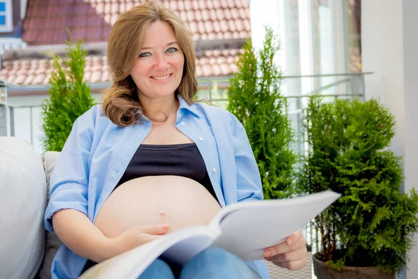 Young Pregnant Woman Reading Book Balcony Home — Stockfoto
