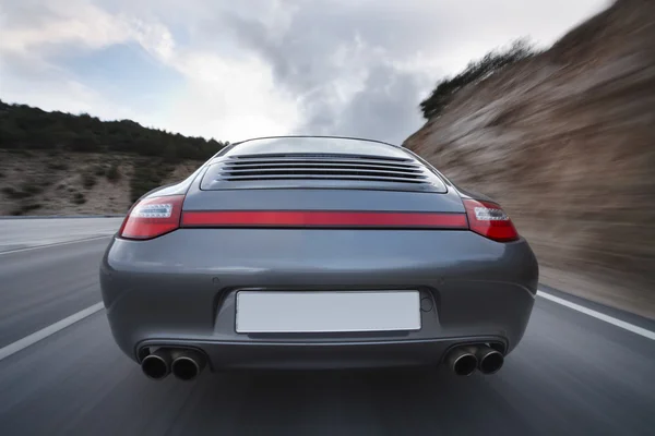 Car Speeding on Country Road — Stockfoto