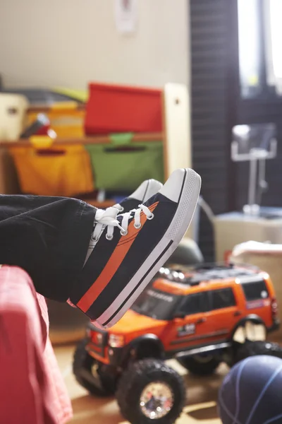 Young boy trainers on bed — Stock Photo, Image