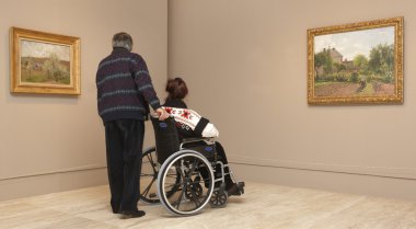 Senior couple on wheelchair inside a Museum