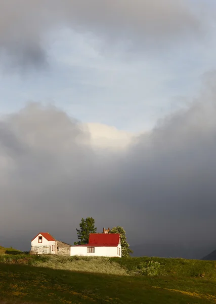 Iceland. Farmhouses near Isafjordur with dramatic sky. — Stock Photo, Image