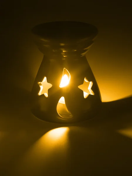 Ceramic ornament with burning candle inside — Stock Photo, Image