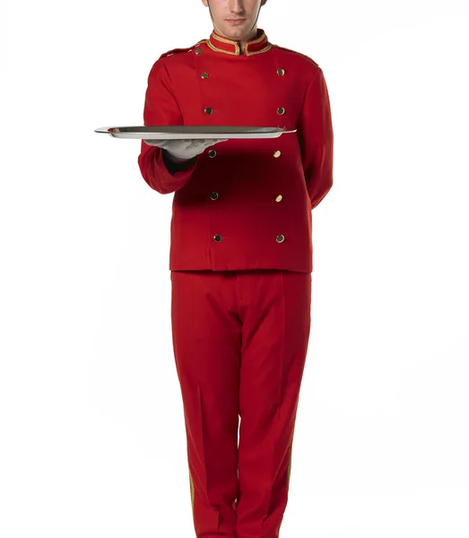 Bellboy with a tray dressed in red. — Stock Photo, Image