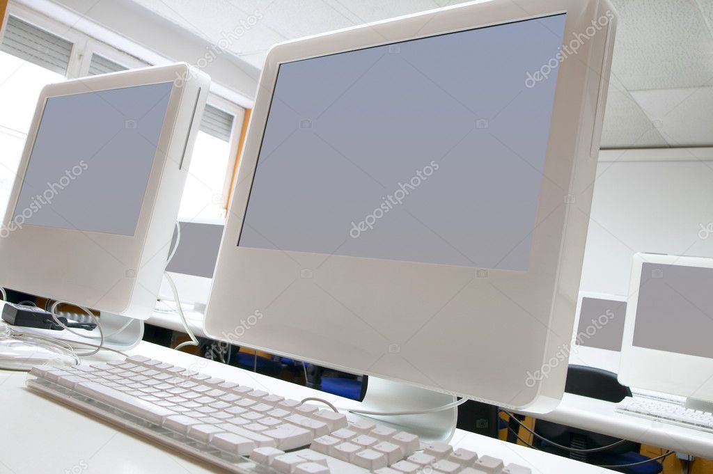 Classroom with white computers details and neutral screens