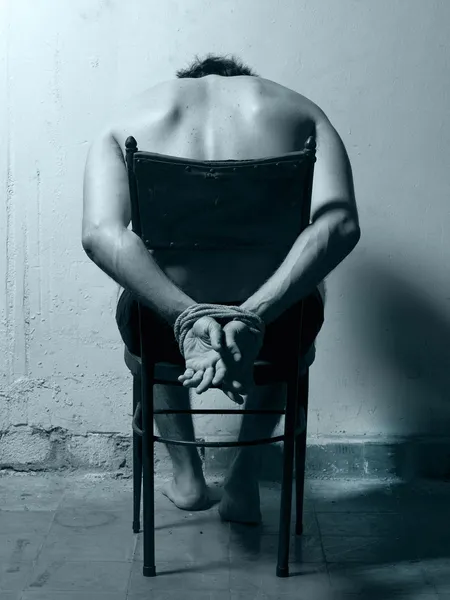 Tortured man in a chair with cold tones — Stock Photo, Image