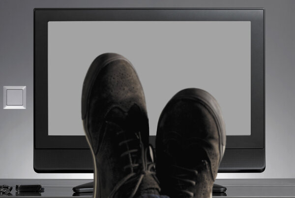 TV and shoes out of focus with neutral background