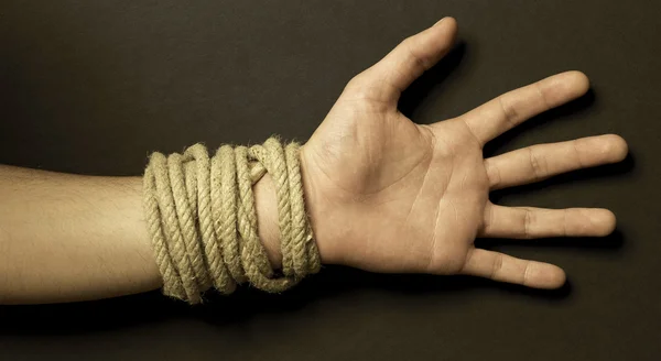Hand with a rope with black background — Stock Photo, Image