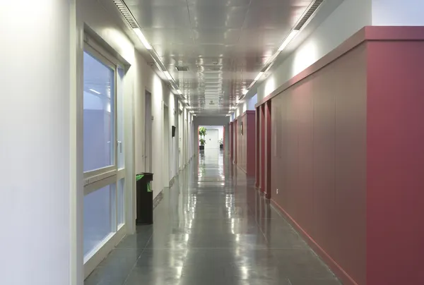 Modern building corridor with red wall — Stock Photo, Image