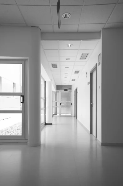 Modern building interior with corridor and exit door — Stock Photo, Image