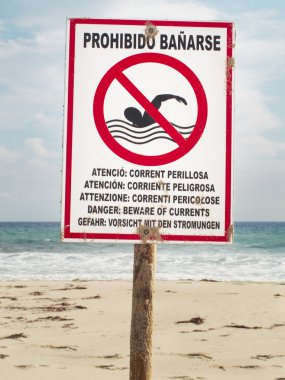 Beware of currents. Signalpost on the beach clipart