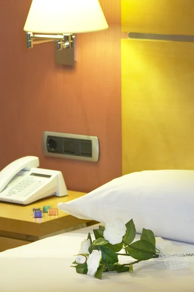 Hotel interior with bed detail in warm tone — Stock Photo, Image