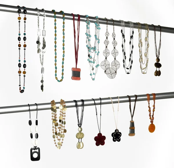 Modern necklaces hanged on a metallic tube — Stock Photo, Image