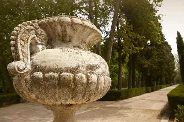Antique marble pots in a garden. Sepia tone.