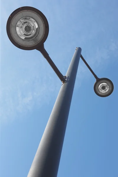 Modern street lamp under a blue sky — Stock Photo, Image