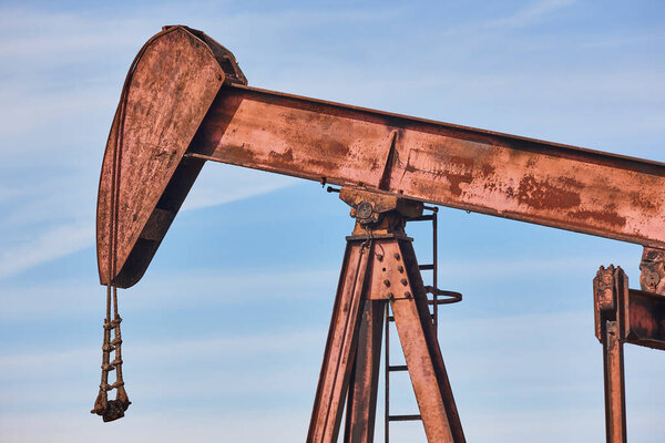 Rusty oil pumping machine. Pump jack in Ayoluengo, Burgos. Spain