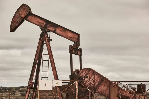 Rusty oil pumping machine. Pump jack in Ayoluengo, Burgos. Spain