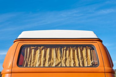 Vintage camper van under a blue sky. Recreational vehicle. Lifestyle