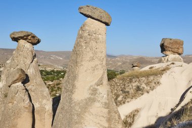 Picturesque chimney rock formations in Cappadocia. Urgup village. Turkey