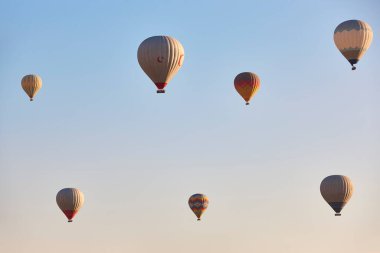 Spectacular balloons flying at sunrise in Goreme valley. Cappadocia, Turkey