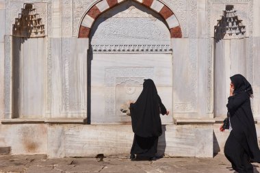Topkapi palace exterior. Ahmet III marble fountain and women. Istanbul