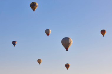 Spectacular balloons flying at sunrise in Goreme valley. Cappadocia, Turkey