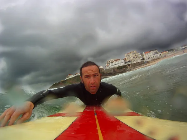 Surfer paddling out