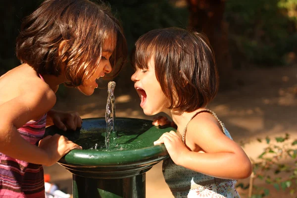 Two little girls smiling and playing outdoors — Stock Photo, Image