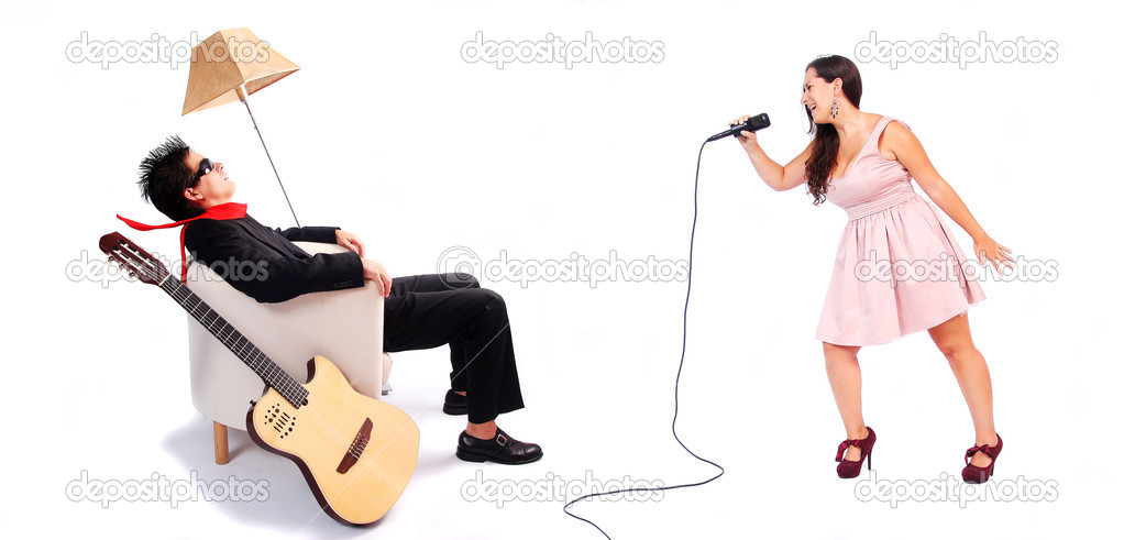 A female singer and a male guitarrist in action