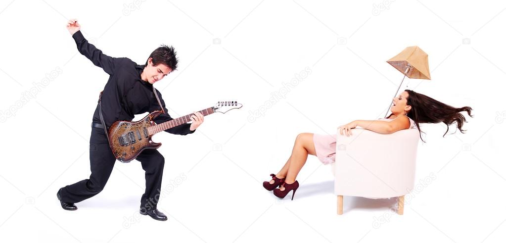 A female singer and a male guitarrist in action