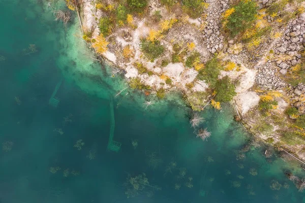 Aerial view of quarry. Environmental problems in flooded quarry, aerial view of industrial quarry with flooded equipments, abandoned and flooded quarry