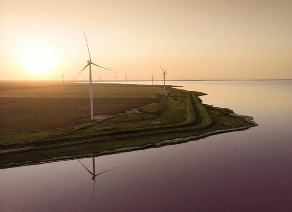 Background of wind farm on the coast of Lemuriiske lake(pink lake) in Kherson district, Ukraine, green energy and agriculture