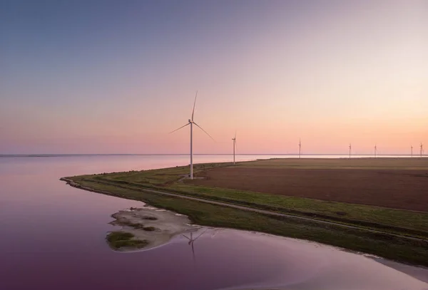 Background of wind farm on the coast of Lemuriiske lake (pink lake) in Kherson district, Ukraine, green energy and agriculture