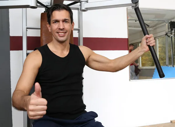 Hombre guapo haciendo ejercicio en un gimnasio — Foto de Stock