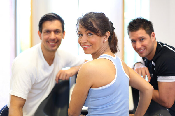 Group of three friends on treadmill smiling