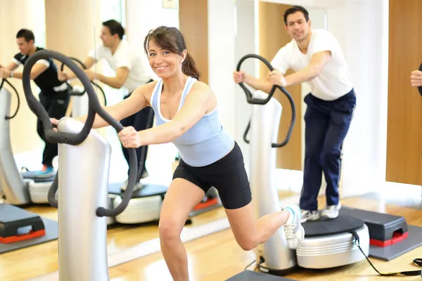 Woman on vibration plate in a gym — Stock Photo, Image