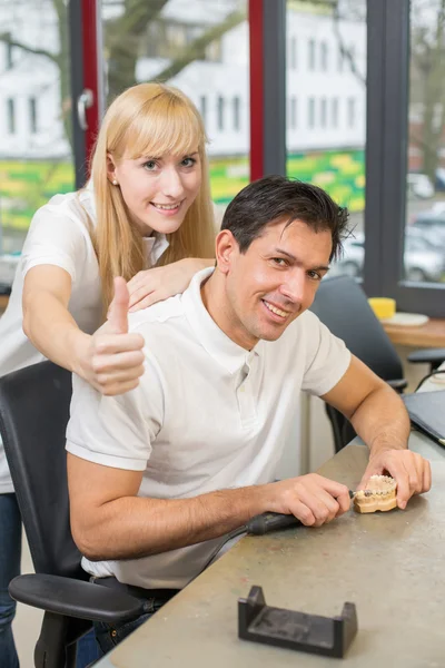 Two technicians in dental lab showing thumbs up — Stock Photo, Image